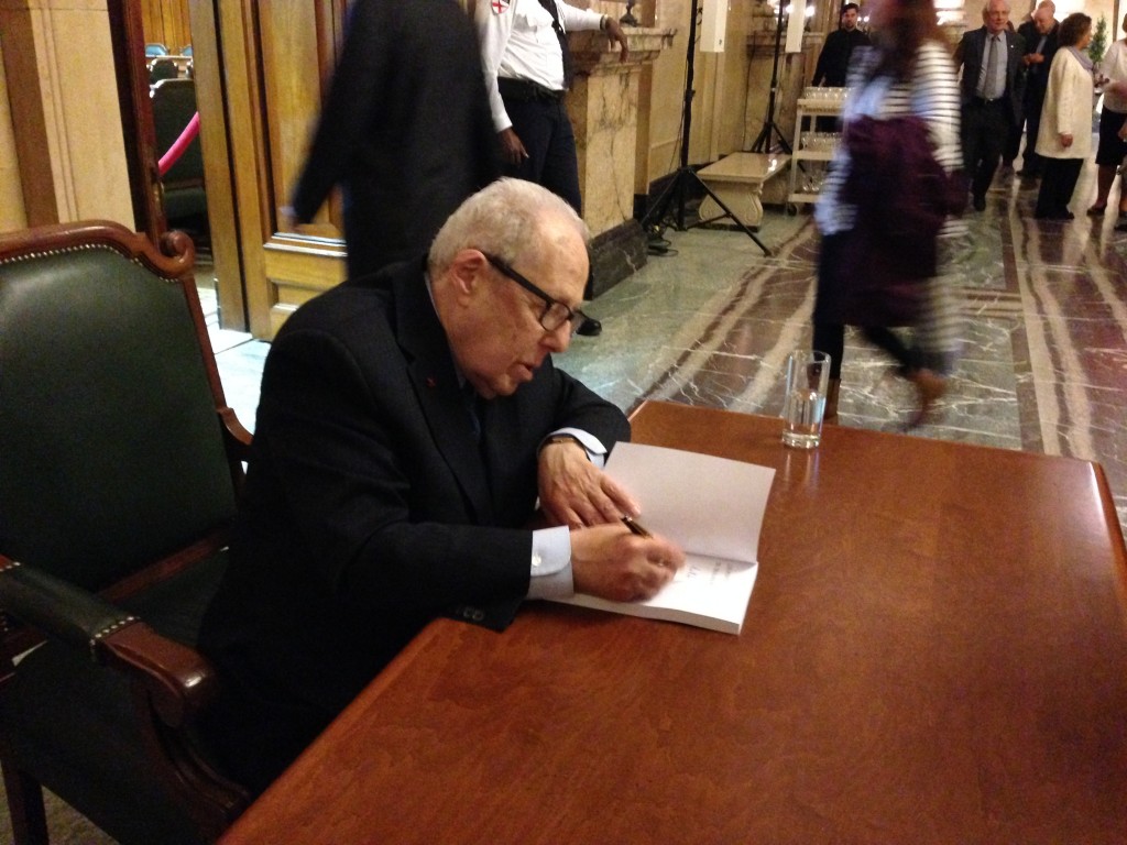 Victor Goldbloom signing copies of his book, Building Bridges.